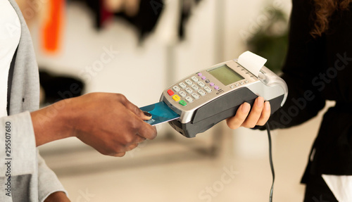 Customer Paying With Credit Card In Fashion Showroom, Closeup, Cropped
