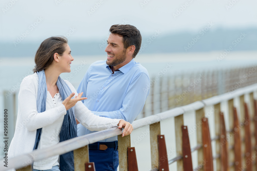 middle aged couple chatting on bridge