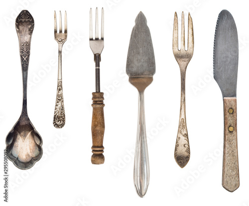 Beautiful old vintage forks. spoons and knife isolated on white background. Top view. Retro silverware