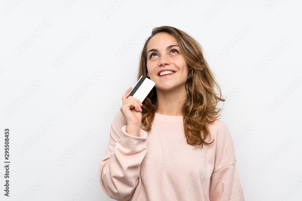 Young blonde woman holding a credit card Young blonde woman holding a credit card