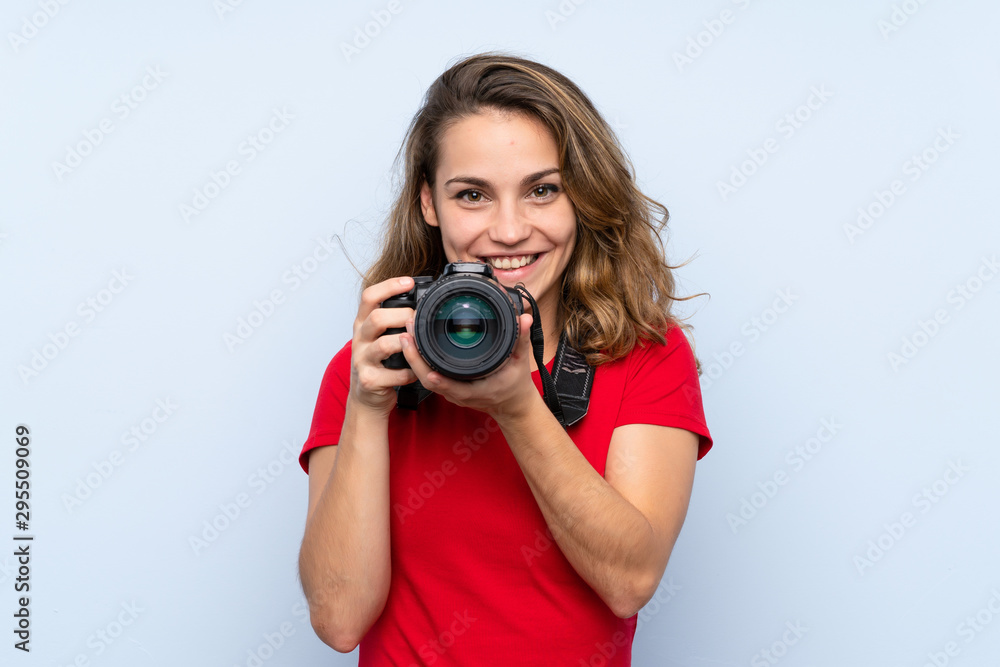 Young blonde woman with a professional camera Young blonde woman with a professional camera