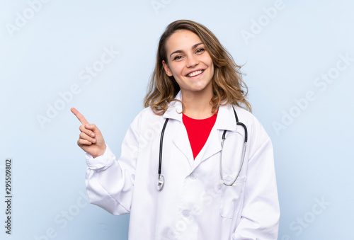 Young blonde woman with doctor gown and pointing side