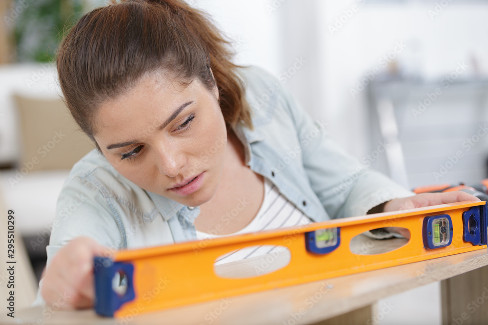 Naklejka premium female worker woman with level on white