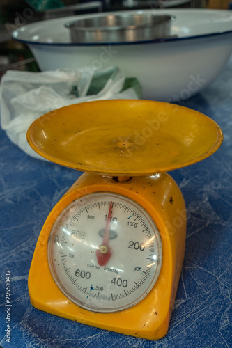 Chon Buri, Thailand - March 16, 2019: Nong Mon market. Closeup of plastic yellow scale with red dial on white at booth. 