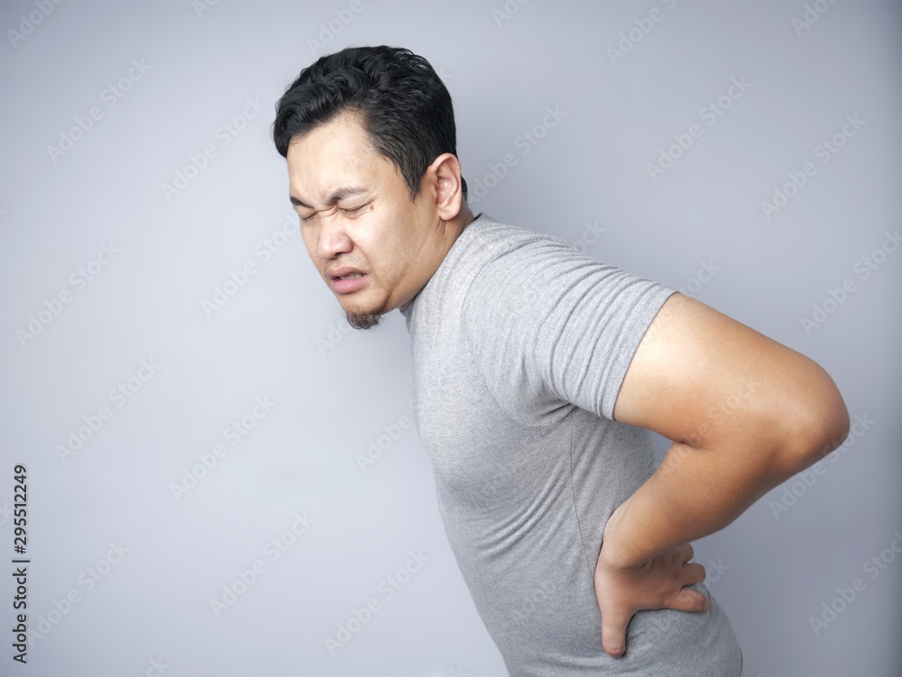 Young Man Suffers From Lower Back Pain Young Man Suffers From Lower Back Pain