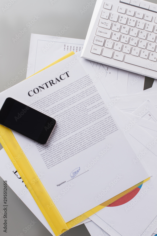 Mobile phone on signed contract. Phone negotiations on contract issue. Business concept. Mobile phone on signed contract. Phone negotiations on contract issue. Business concept.