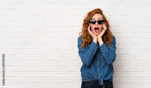 Redhead woman over white br...