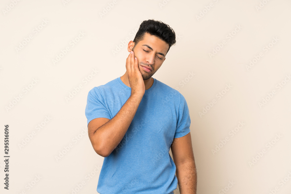 Young handsome man over isolated background with toothache Young handsome man over isolated background with toothache