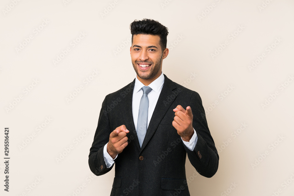Young handsome businessman man over isolated background points finger at you Young handsome businessman man over isolated background points finger at you