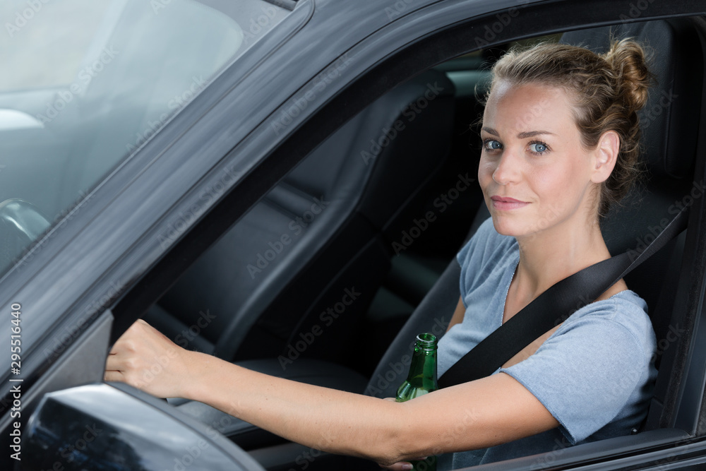 woman driver is drinking beer a