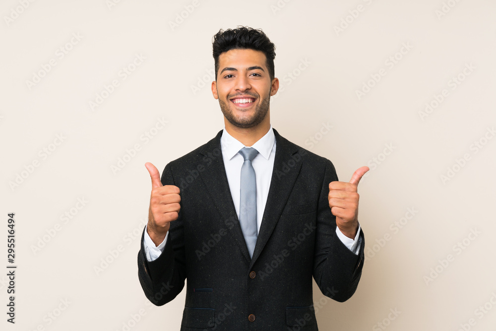 Young handsome businessman man over isolated background giving a thumbs up gesture Young handsome businessman man over isolated background giving a thumbs up gesture
