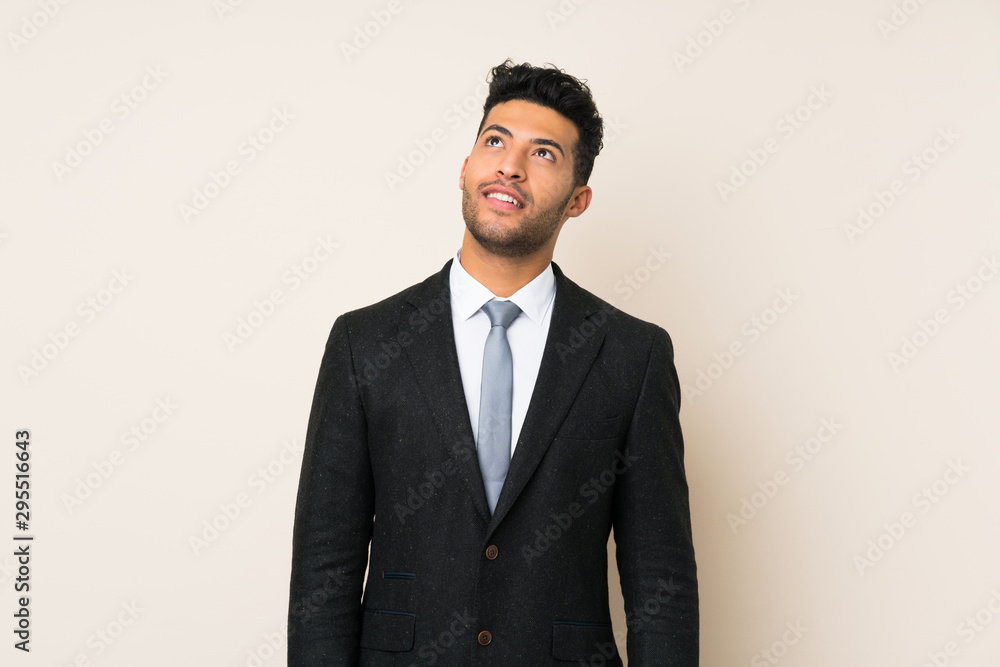 Young handsome businessman man over isolated background laughing and looking up Young handsome businessman man over isolated background laughing and looking up