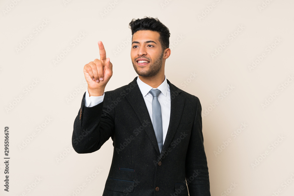 Young handsome businessman man over isolated background touching on transparent screen Young handsome businessman man over isolated background touching on transparent screen