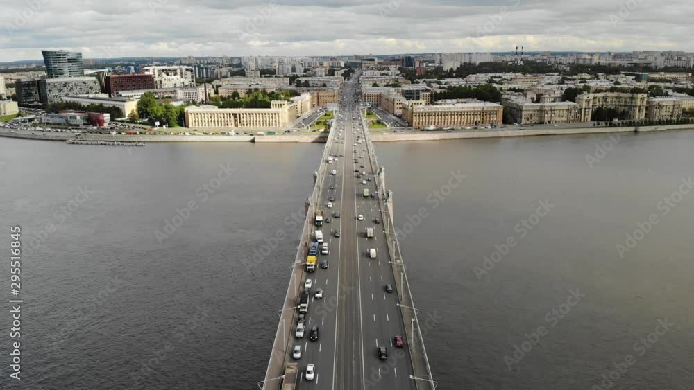 flying over Aerial view to bridge in Saint-Petersburg near Neva river. road junction with cloudy sky and normal traffic flying over Aerial view to bridge in Saint-Petersburg near Neva river. road junction with cloudy sky and normal traffic