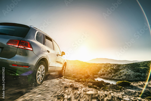SUV car in spain mountain landscape road at sunset