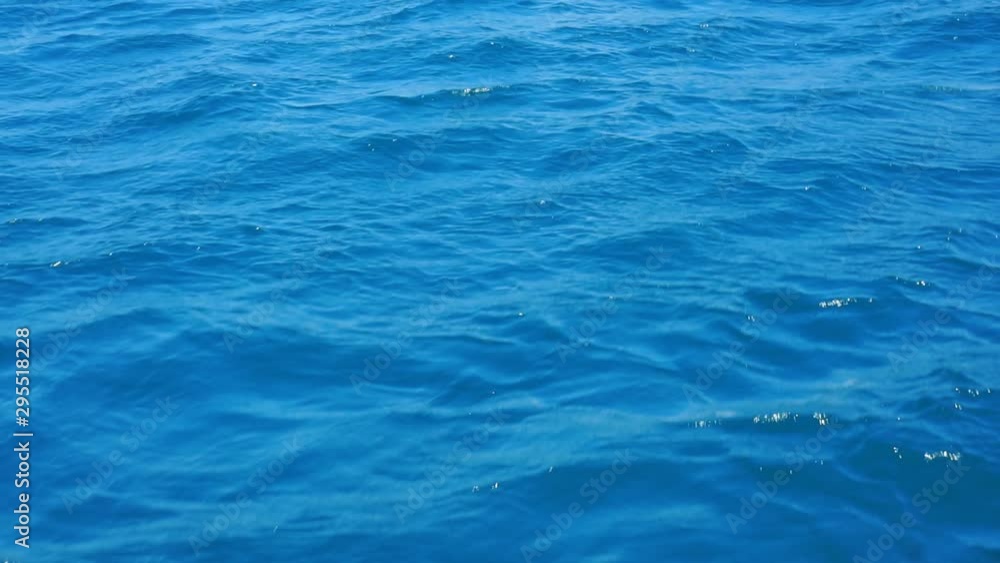 The surface of the blue sea, ocean waves on a sunny day with sunlight on the surface. Background of blue ocean surface.1920X1080 Full Hd. The surface of the blue sea, ocean waves on a sunny day with sunlight on the surface. Background of blue ocean surface.1920X1080 Full Hd.
