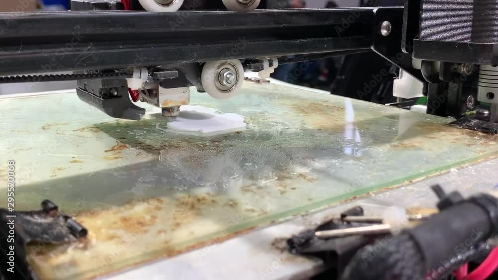 3D printer working close up. Automatic three dimensional 3d printer performs plastic. Modern 3D printer printing an object from the hot molten. 3D printer working close up. Automatic three dimensional 3d printer performs plastic. Modern 3D printer printing an object from the hot molten.