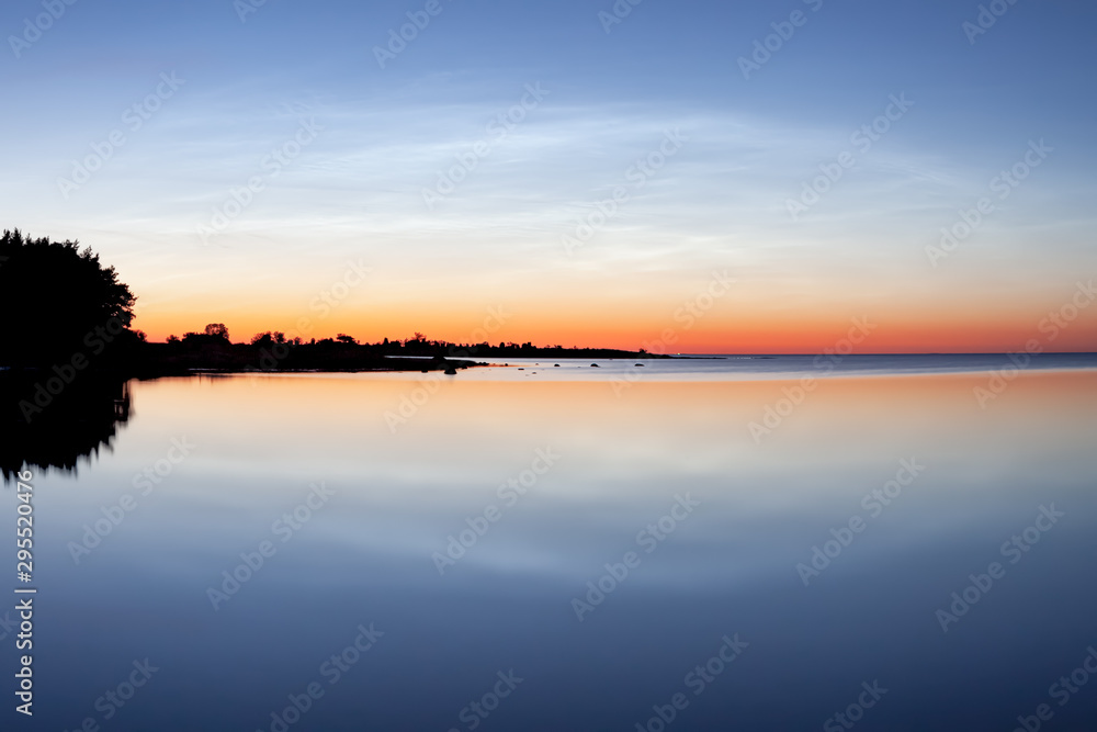 Sunset over ocean horizon. The blue hour in the swedish summer evening at the island of Gotland.