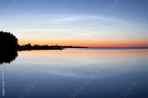 Sunset over ocean horizon. The blue hour in the swedish summer evening at the island of Gotland.