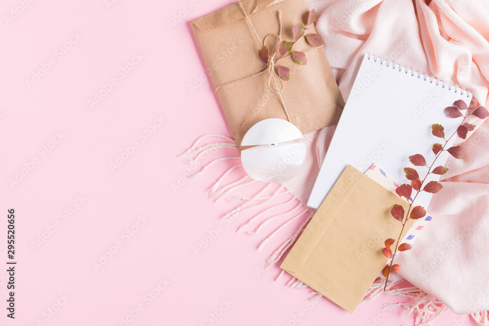 Warm pink scarf perfume bottle, envelope and blank paper on a pink paper background. Autumn concept. top view copy space Warm pink scarf perfume bottle, envelope and blank paper on a pink paper background. Autumn concept. top view copy space