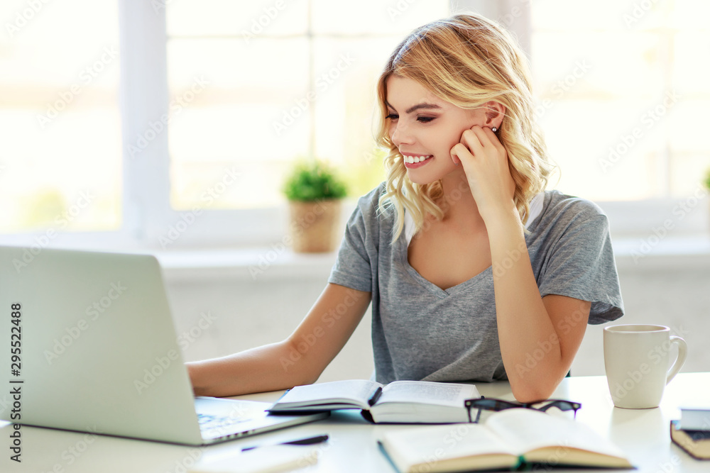 happy young girl working at computer at home happy young girl working at computer at home