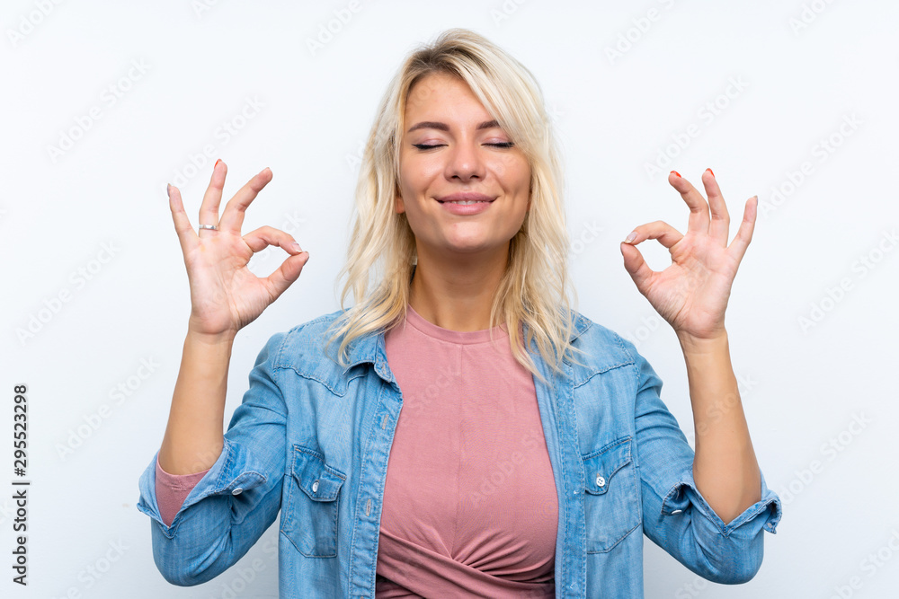 Young blonde woman over isolated white background in zen pose Young blonde woman over isolated white background in zen pose