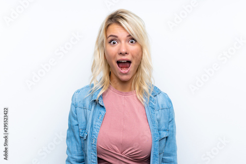 Young blonde woman over isolated white background with surprise facial expression