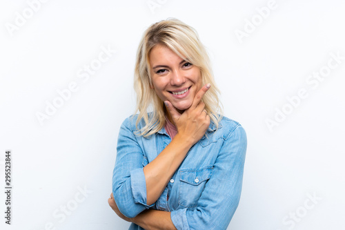 Young blonde woman over isolated white background smiling
