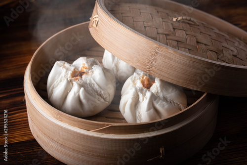 chinese steamed bun in traditional bamboo steamer photo