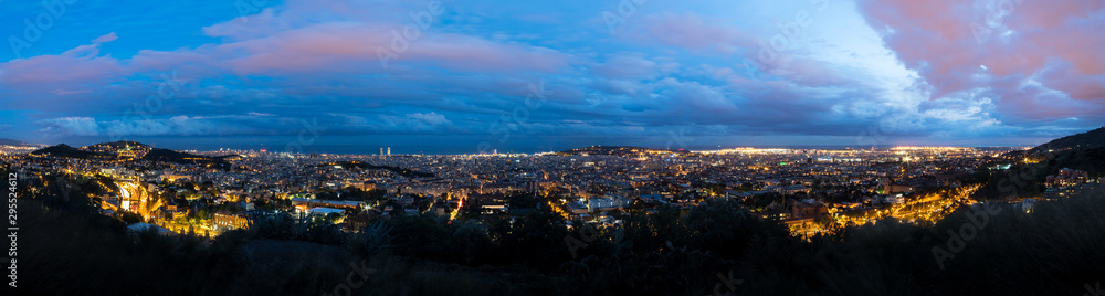Panoramic view of Barcelona from the Tibidabo hillside at dusk after a storm