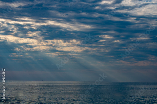 The rays of the summer sun make their way through the thick clouds over the Black Sea in the evening © Valentin