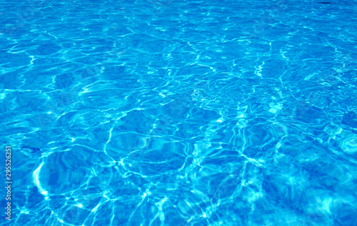 Blue pool water with sun reflections © Pakhnyushchyy