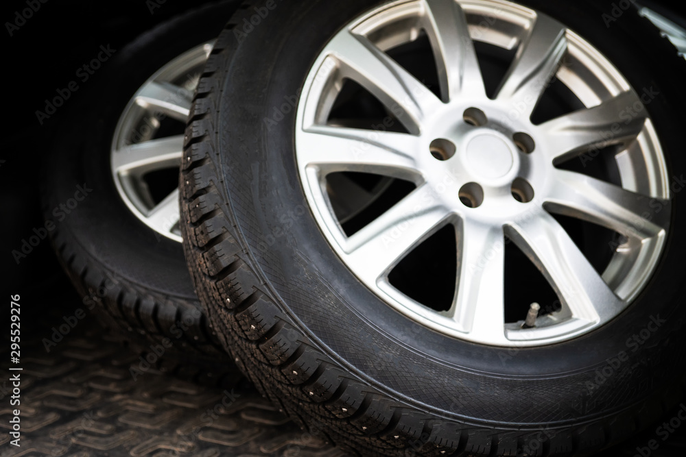 The wheels are in the trunk of the car. Concept: replacement of summer rubber for winter. Selective focus. The wheels are in the trunk of the car. Concept: replacement of summer rubber for winter. Selective focus.