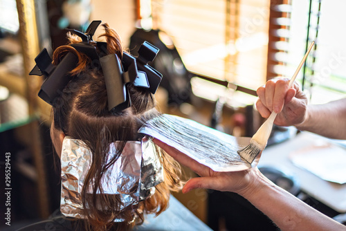 New hair color. Hairdresser cutting client's hair in beauty salon