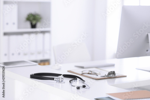 Stethoscope, prescription medical form lying on a table with pc computer. Medicine or pharmacy concept. Medical tools at doctor working table