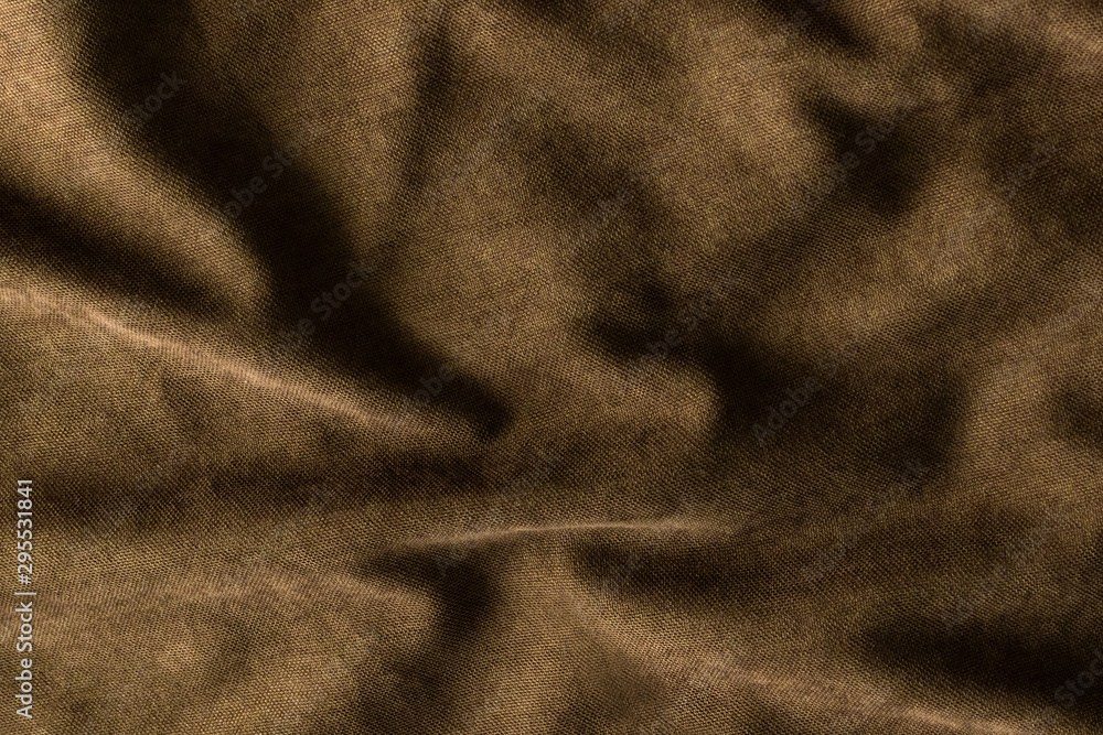 Top view of empty, abstract template - crumpled dense fabric of a dark brown hue with waves and folds background and texture. Top view of empty, abstract template - crumpled dense fabric of a dark brown hue with waves and folds background and texture.