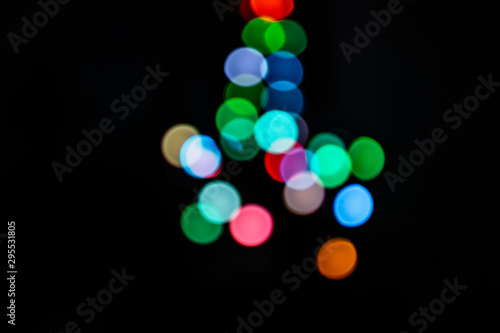 Bild auf Leinwand multicolored bokeh lights on a black background in the silhouette of a Christmas