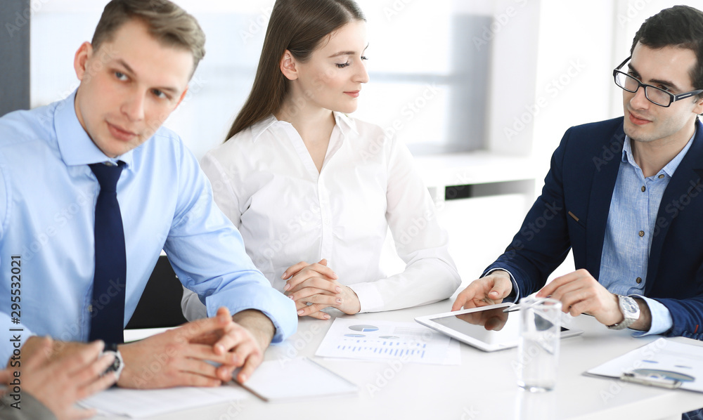 Group of business people discussing questions at meeting in modern office. Managers at negotiation or brainstorm. Teamwork, partnership and business concept Group of business people discussing questions at meeting in modern office. Managers at negotiation or brainstorm. Teamwork, partnership and business concept