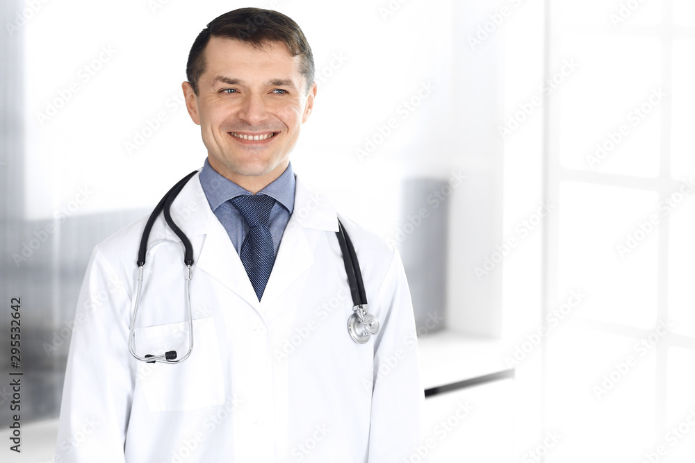 Doctor man cheerful smiling at camera. Perfect medical service in clinic. Happy future in medicine and healthcare Doctor man cheerful smiling at camera. Perfect medical service in clinic. Happy future in medicine and healthcare