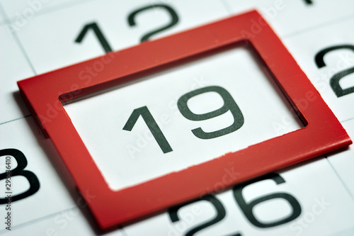 nineteenth day of the month highlighted on the calendar with a red frame close-up macro, mark on the calendar, nineteenth date