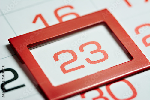 twenty-third day of the month highlighted on the calendar with a red frame close-up macro, mark on the calendar, twenty-third date