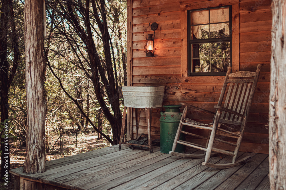 Rocking chair on the cabin front porch in the woods