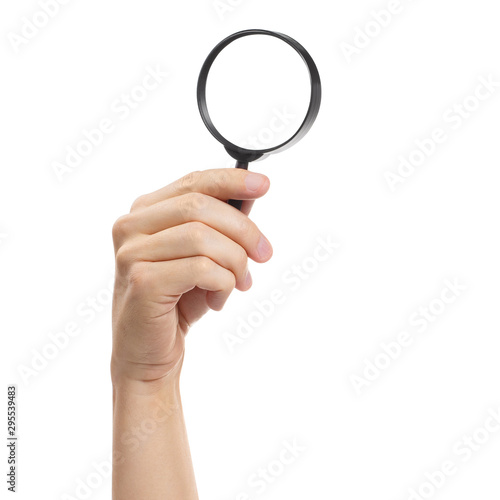 Hand holding a magnifying glass, isolated on white background