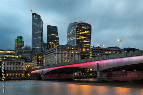 Skyline of the City of London by the river Thames at dusk