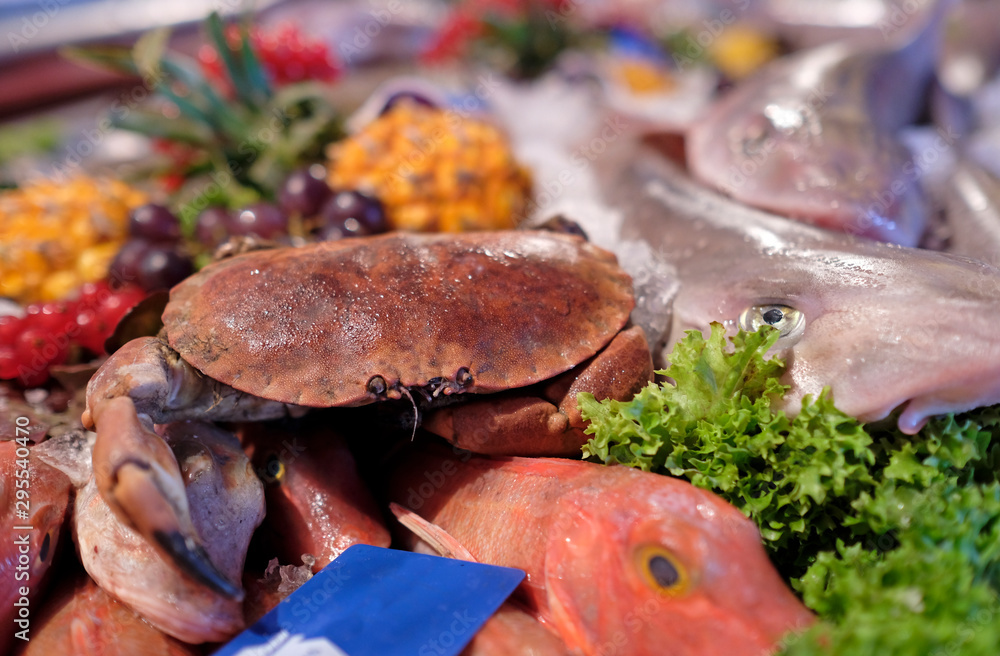 Fish and other seafood on ice on display at a fish market Fish and other seafood on ice on display at a fish market
