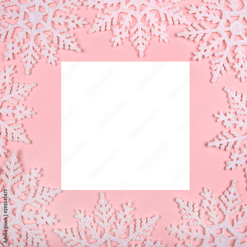 Winter pattern made of snowflakes and on pink background. Christmas concept. Flat lay. Copy space for your text.