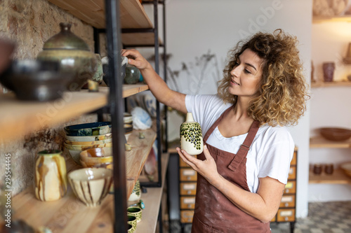 Portrait of woman pottery artist in art studio photo