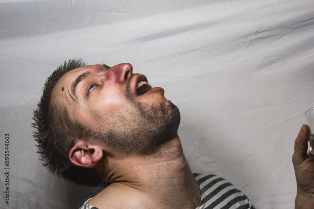 Obraz premium male alcoholism. drinking father, a man drinks vodka. feeling unwell. assault, booze at home. stop alcohol