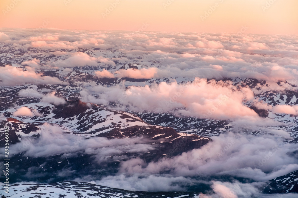 Aerial view of snowy landscape in winter with mountains and lakes in Norway at sunset Aerial view of snowy landscape in winter with mountains and lakes in Norway at sunset