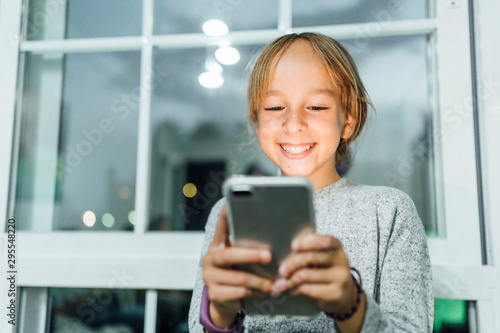 Little girl with Smartphone in the house